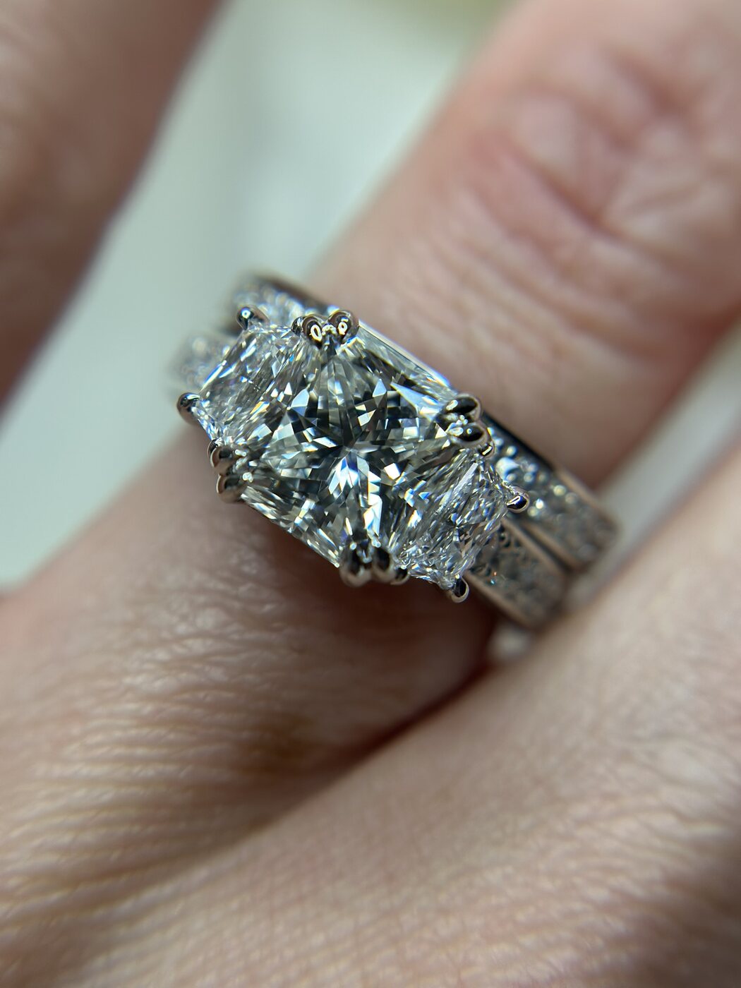 Finished custom engagement ring worn on hand