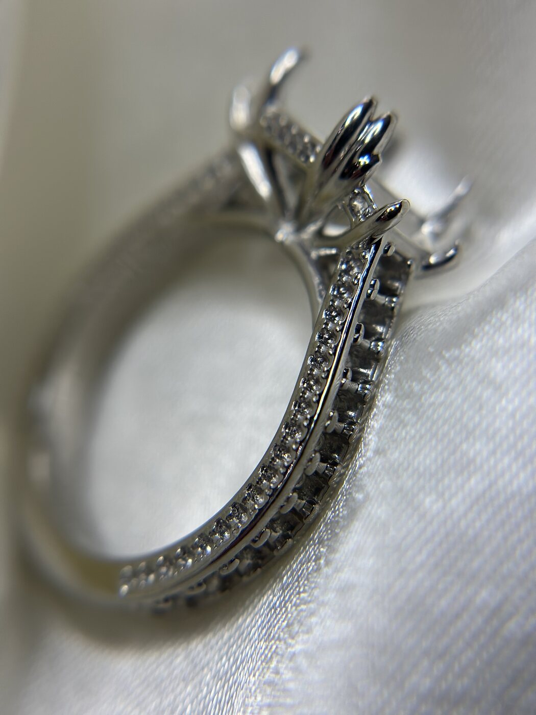 Close detail of custom ring side stones and prongs